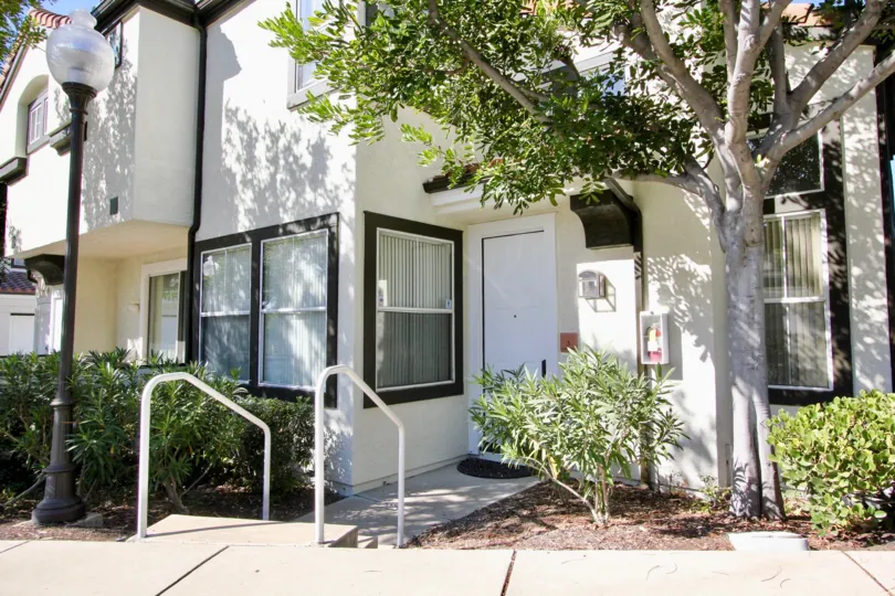 a house entrance well maintained and white finish with elegant look l