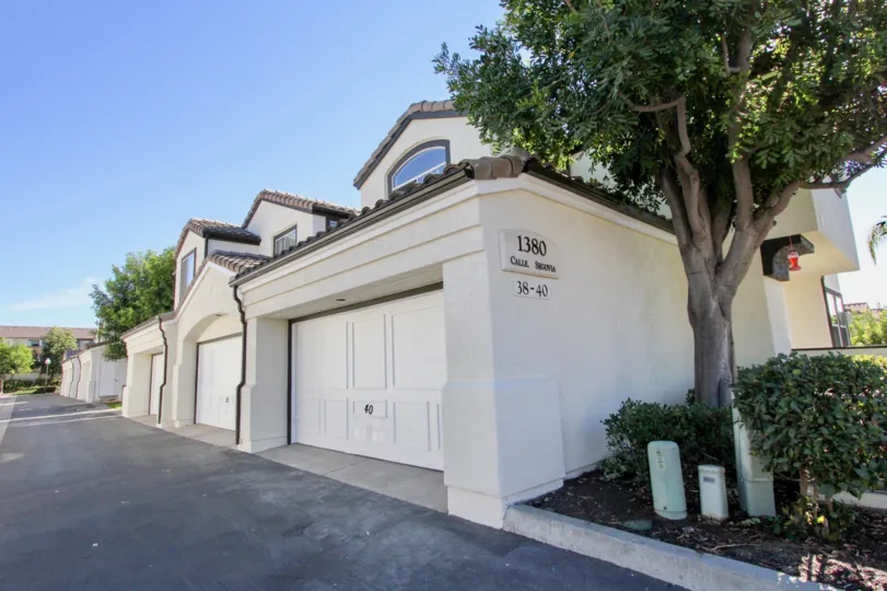 Sunny day side view with garage door and walkway, Tiara Community, Chula Vista, CA