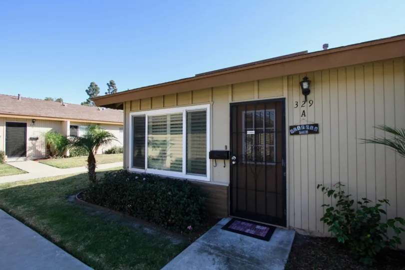 A clear day with the front of a one story home in Treehaven