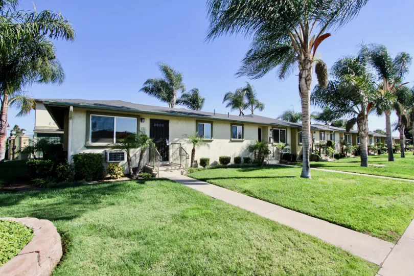 Front yard decorated with plants and trees in front of the building in Twin Oaks