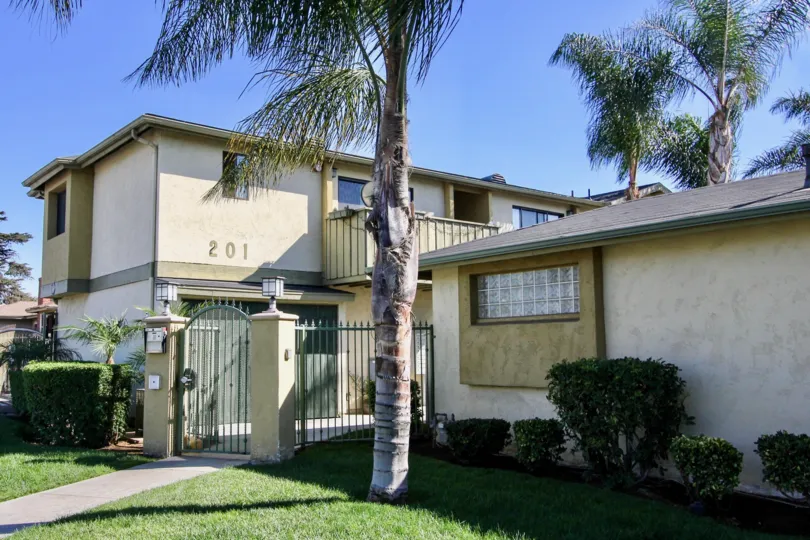 A sunny day with a private house and palm trees in Twin Oaks.