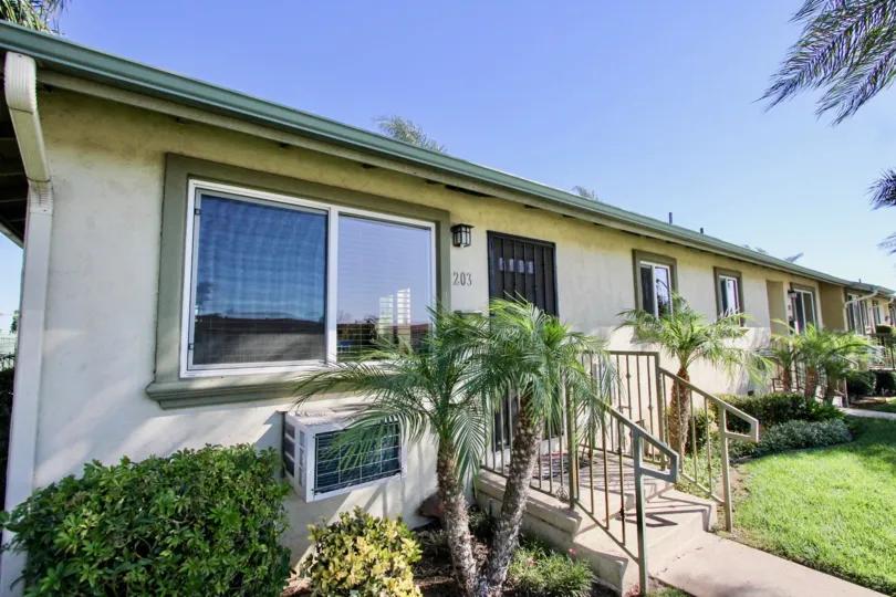 THE HOUSE NUMBER 243 IN THE TWIN OAKS WITH THE STEPS, AIR CONDITIONER, GRASS, PLANTS