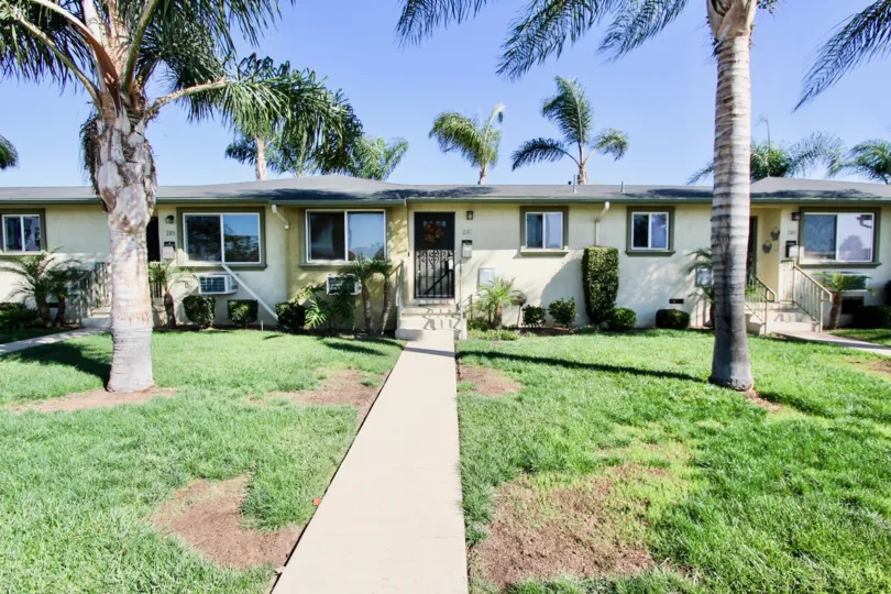 Bungalow style houses with mature palm trees and sizeable front yards in Twin Oaks
