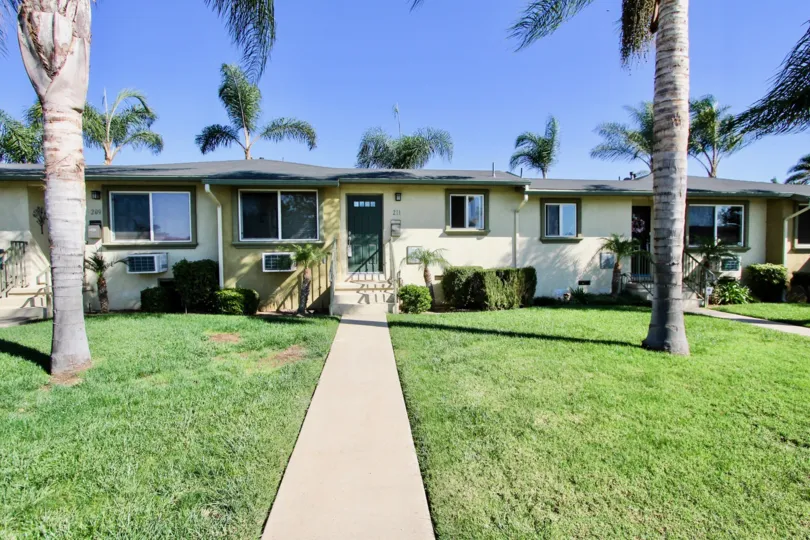 Front yard decorated with plants and trees in front of the building and trees in back side too in Twin Oaks