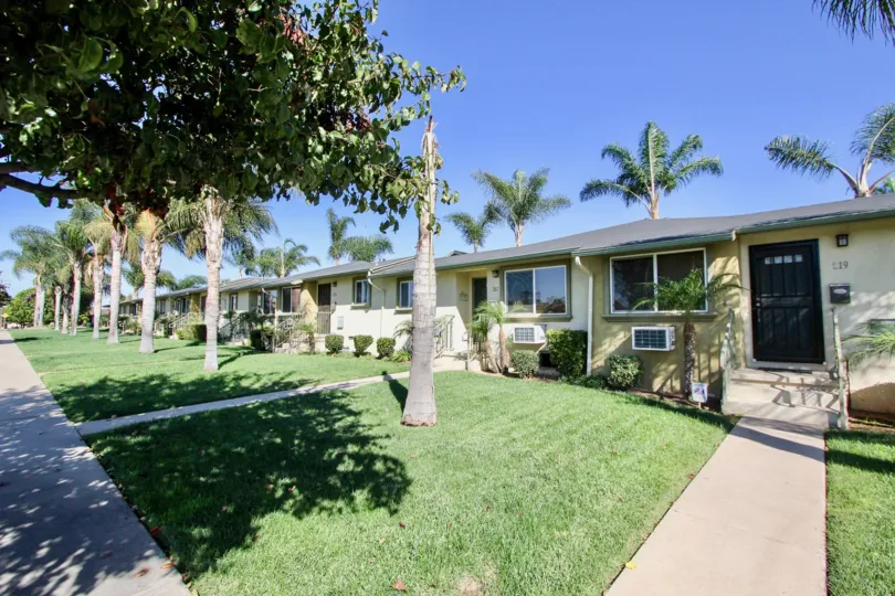 A sunny day in the area of Twin Oaks, outside, palm trees, air conditioners, sidewalk, door, mailbox