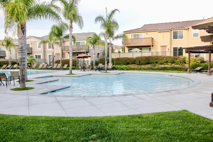 View of the outdoor pool, sunbathing and lounging area for Veranza at Chula Vista, CA.