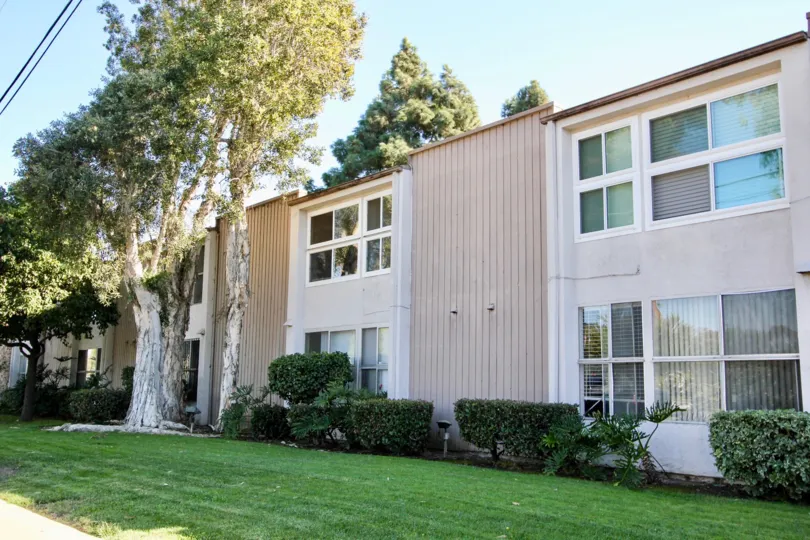 Green mown lawn, shrubs, and shade trees at Villa Campestre community in Chula Vista, California