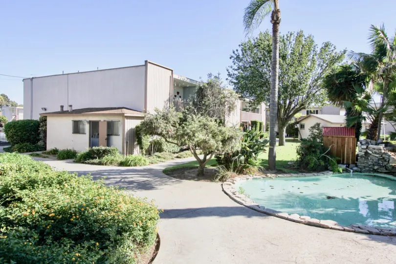 THE BUILDING IN THE VILLA CAMPESTRE WITH THE PLANTS, TREES, GRASS, UNCLEANED WATER