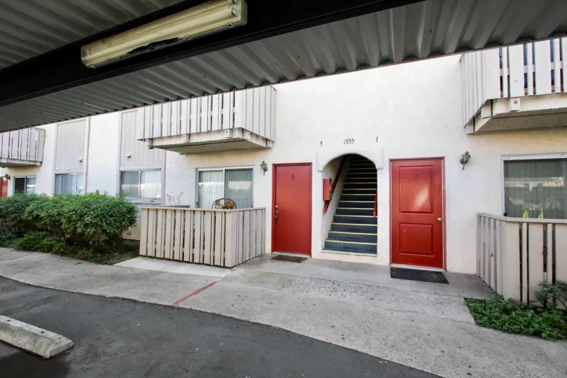A sunny day in the area of Villa De Anita, outside, porch, curb, red doors, stairs, driveway