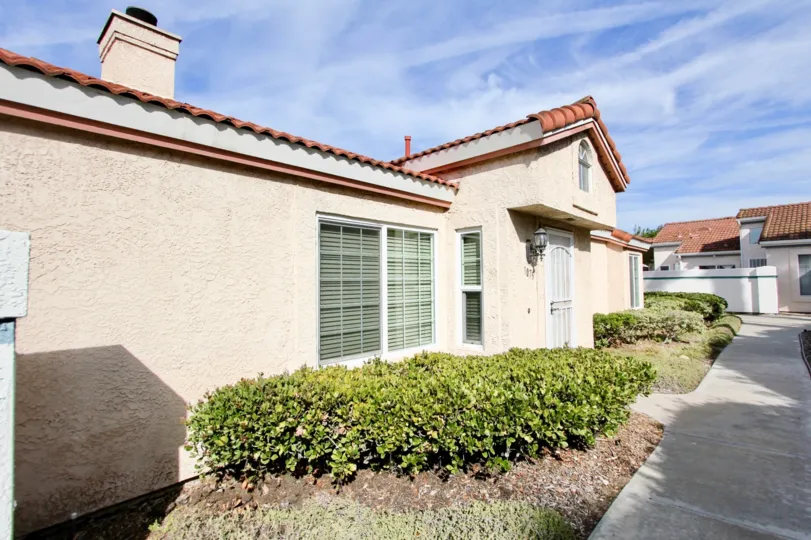 A sunny day in the area of Villa Palmera, bushes, roof, chimney, sidewalk, door