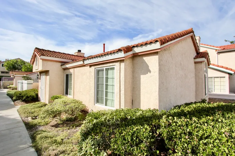 One story Villa Palmera with minimal landscaping on a clear day