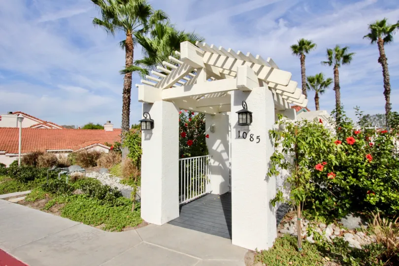 Entryway to #1085 in Villa Palmera with foliage and lighting in Chula Vista, CA