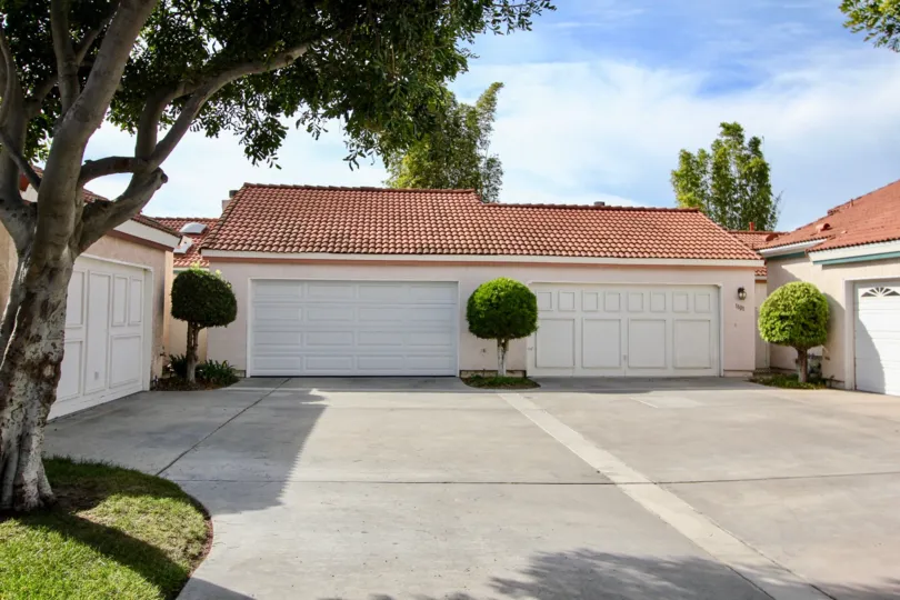 A sunny day in the Villa Palmera area of Chula Vista with a series of white garage doors.