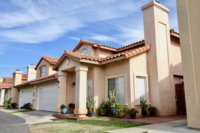 A traditional house painted in cream color of the Villa Rosa community.