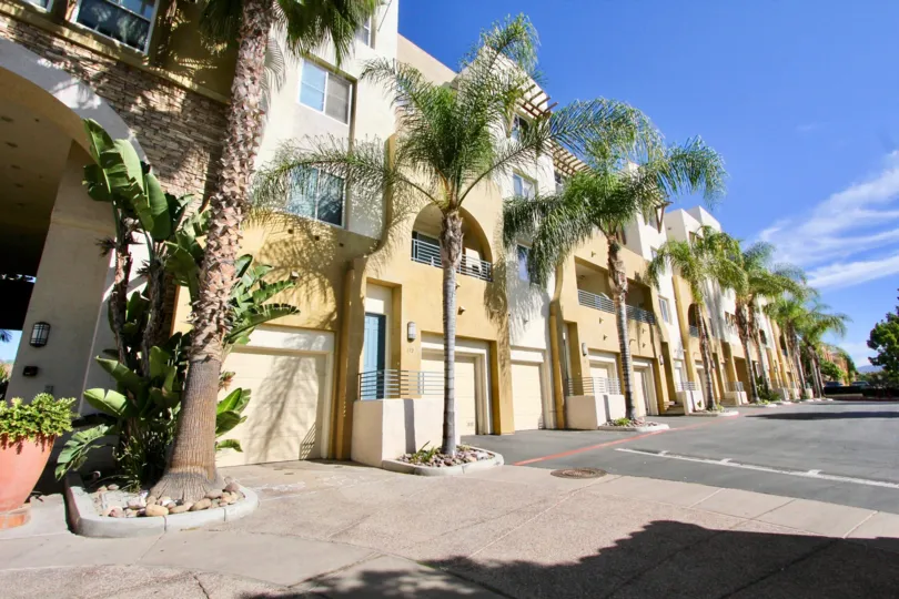 Sunny day side view with trees and garage, Villagio Community, Chula Vista, CA