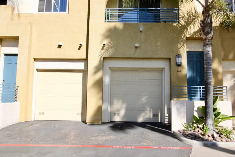 A sunny day in the area of Villagio, outside, garages, palm tree, balcony, driveway, shadows