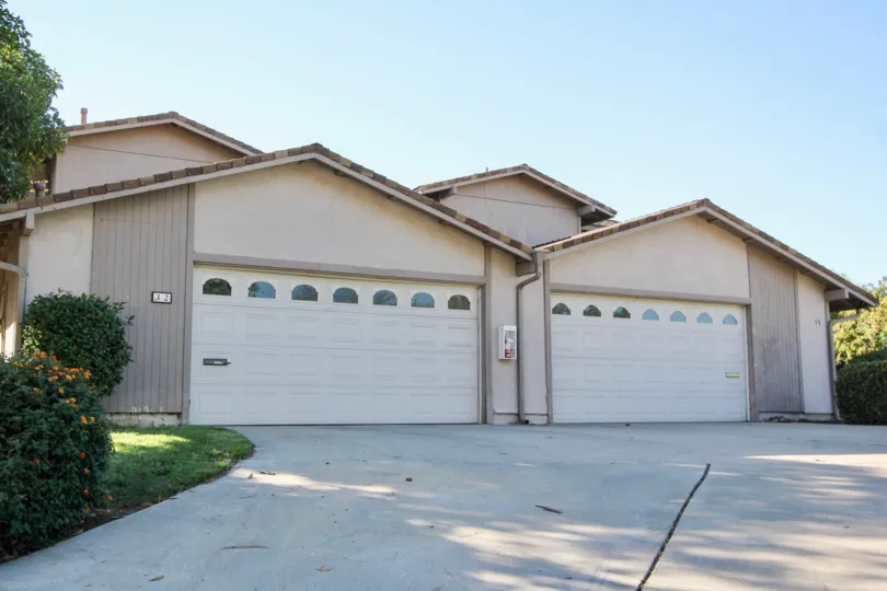A house located in Windsor Heights community in Chula Vista, California. Has two garage doors and shows the driveway.