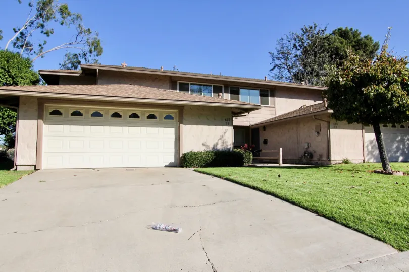 Beautiful landscape and large garage door of a home in Windsor Heights.