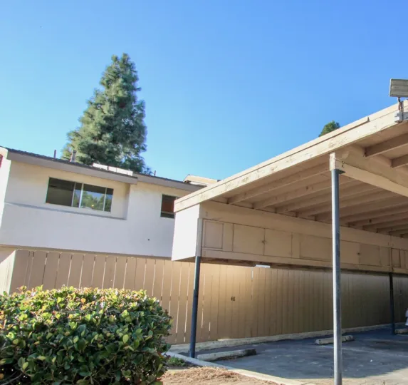 The outside gate of woodside Villahe and their carport area in Chula Vista