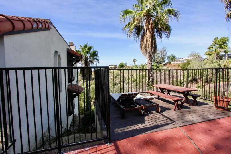 Bay Vista Community Clairemont Mesa California palm tree picnic tables lounge chairs fence patio balcony landscaping tile roof arched windows Spanish style