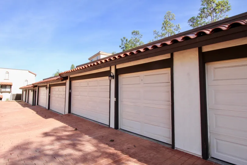Driveway lined with parking garages at Bay Vista in Clairemont Mesa California