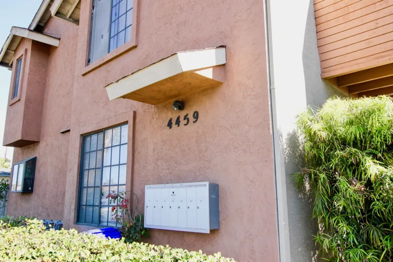 A sunny day in the area of Clairemont 5, outside, bushes, mailboxes, doors, windows, condos