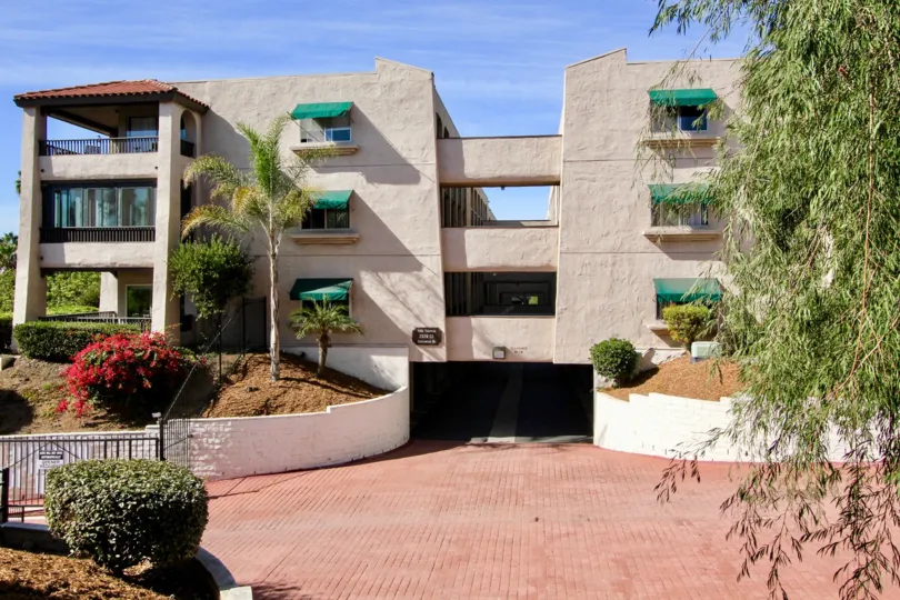 A sunny day a beatiful building in the Costa Viva with some flowering shurbs and have the pavements.