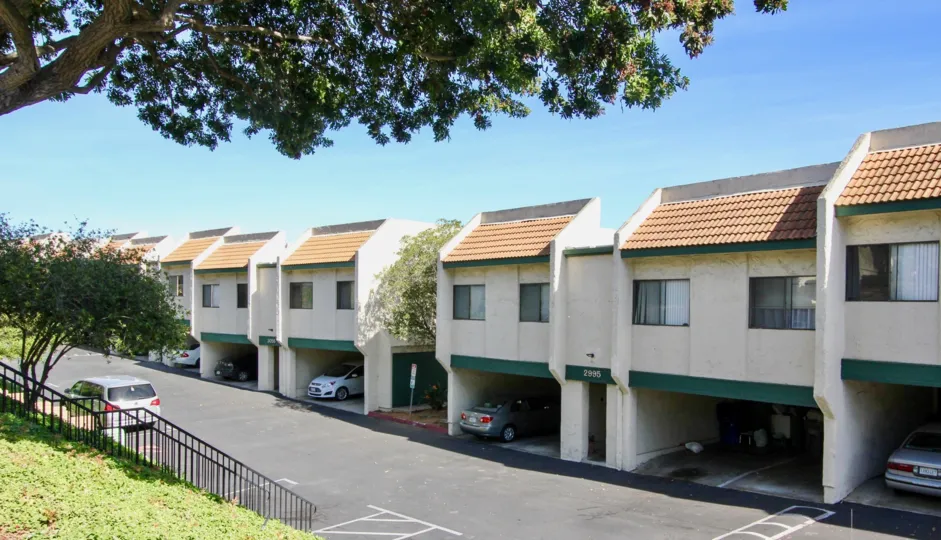 Multiple off white units with covered parking located in Forest Park Plaza of Clairemont Mesa, California