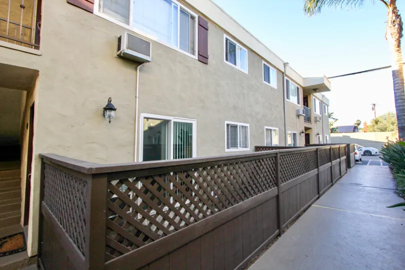 Heritage Park East Apartment Complex with fence and sidewalk