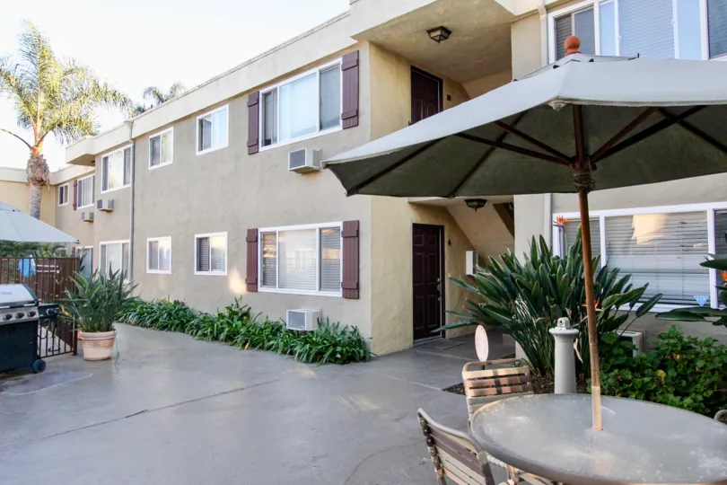 Courtyard view with bbq grill, outdoor patio and view of apartments in Heritage Park East located in Clairemont Mesa California