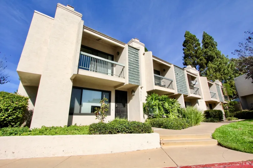 THE APARTMENT IN THE PACIFIC RACQUET CLUB WITH THE STEPS, LAWN, GATE, BALCONIS