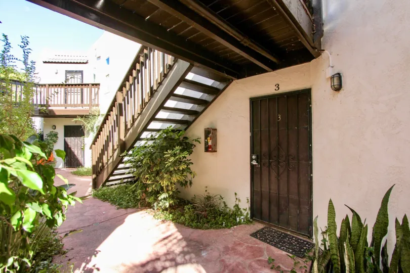 Front door underneath the stairway of a residential building at Amherst Estates in College Area California