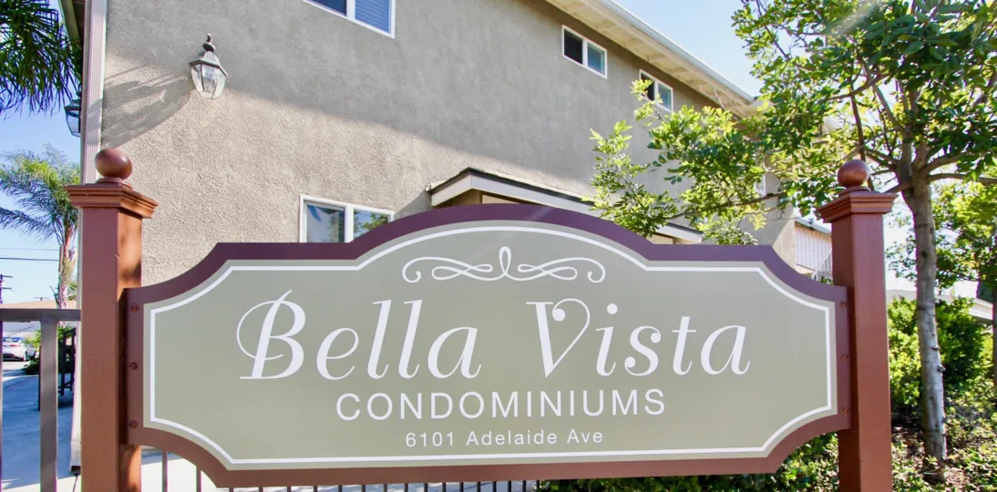 the Bella Vista with name board on the front entrance and tall trees around