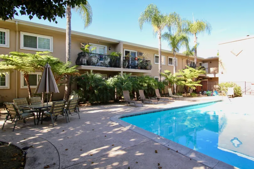 The Carriage House with large swimming pool and a table with chairs