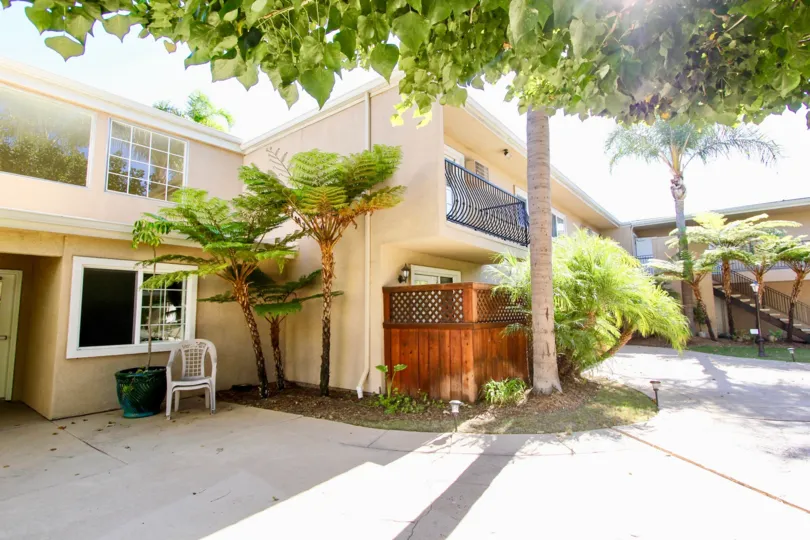 Walkway in front of a two story residential building at Carriage House in College Area California