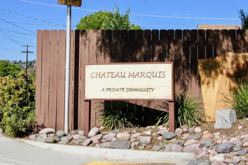 Community sign along side driveway entrance at Chateau Marquis in College Area California