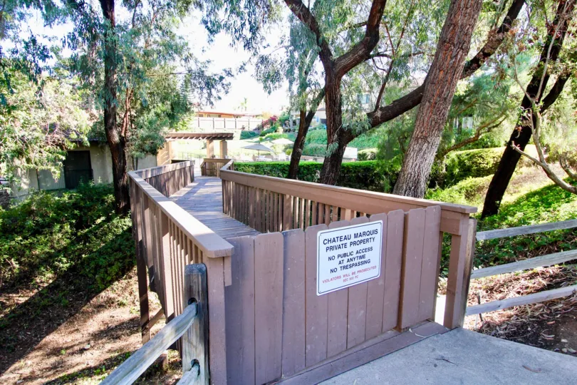 Wooden boardwalk leading up to residential area at Chateau Marquis in College Area California