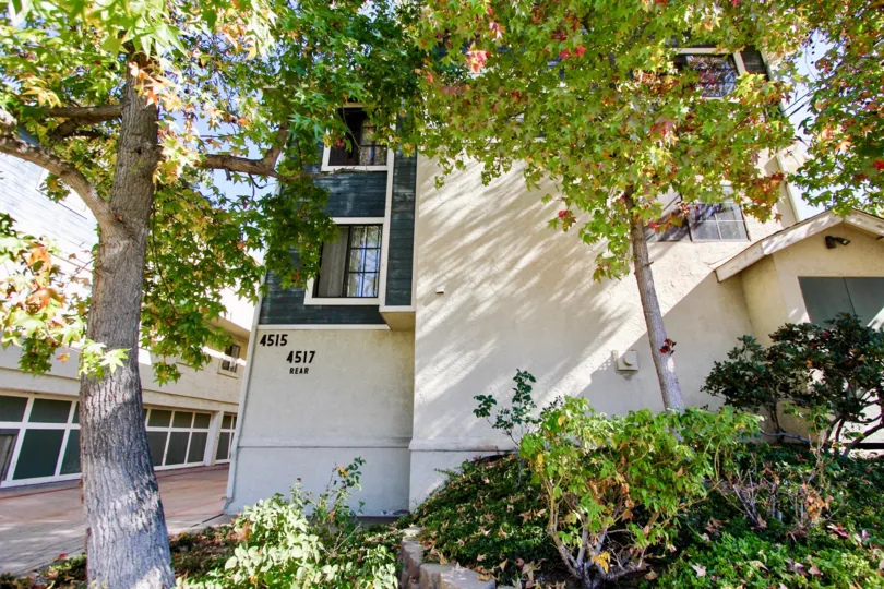 Three story apartment complex with trees and plants at College Way in College Area California