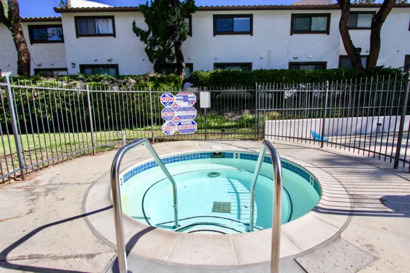 A swimming pool in Collwood Meadows with some buildings around.