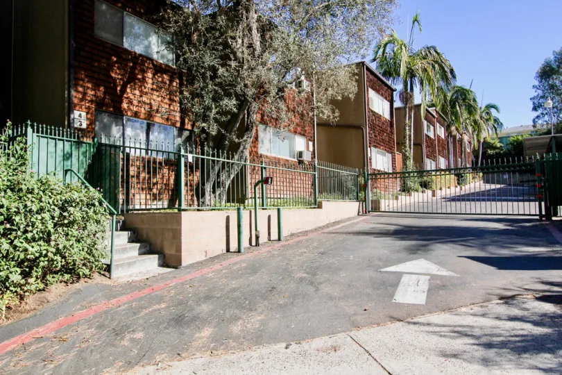 A security gate leading up to brick buildings in Collwood Townhomes