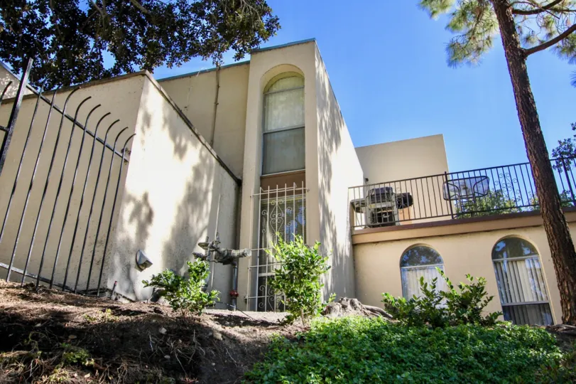 Hillside next to a large white residential building at Collwood Villas in College Area California
