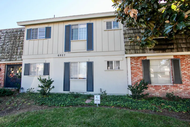 Two story residential building surrounded by grass at Colonial House in College Area California