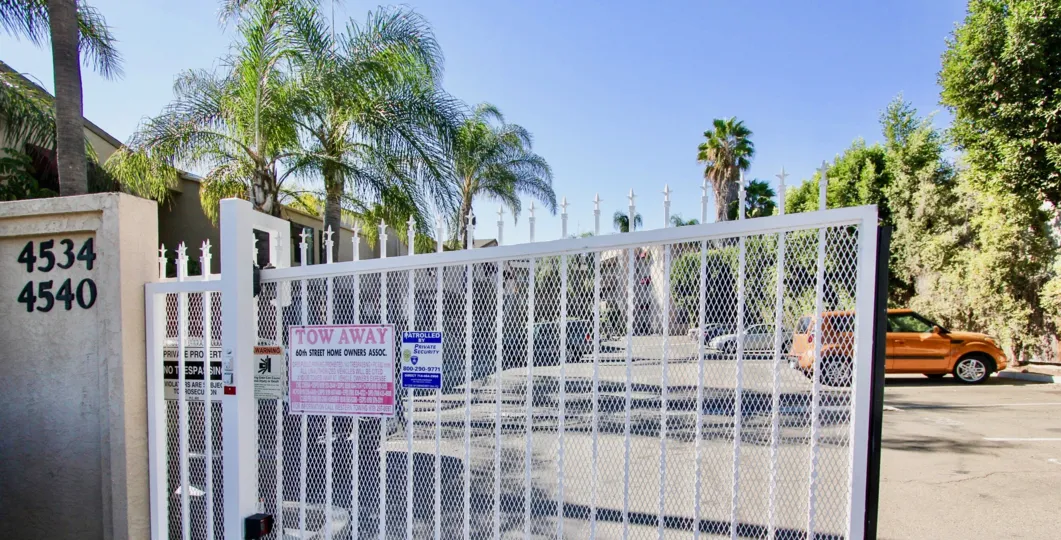 A picture of a Glenridge gated community with lots of palm trees, large parking lot