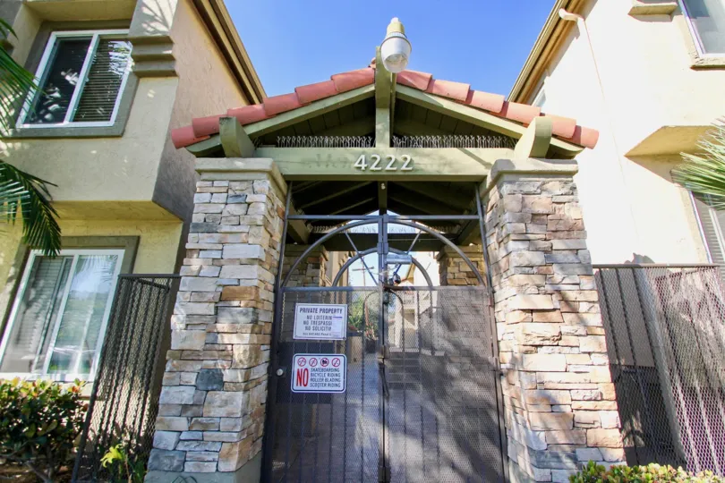 THE 4222 APARTMENT IN THE MENLO VILLAGE, WITH THE TREES, PLANTS, STEEL GATE