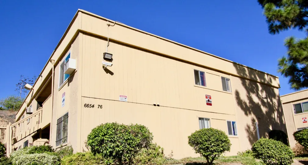 Two story residential unit surrounded by plants at Mesa Greens in College Area California