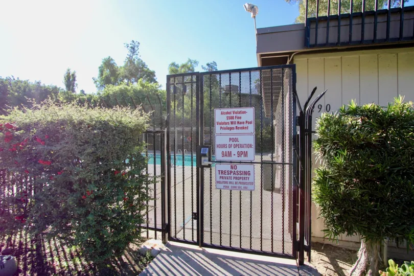 Security gate entrance to pool area at Montezuma Townhomes in College Area California