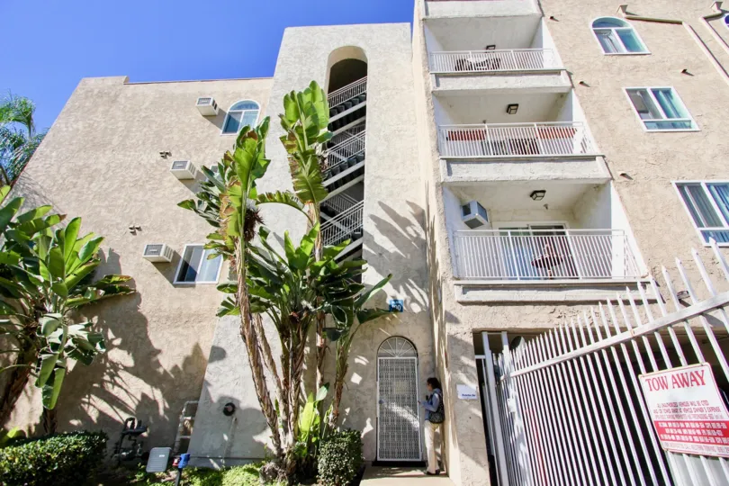Four story residential building with palm trees at Parkridge in College Area California