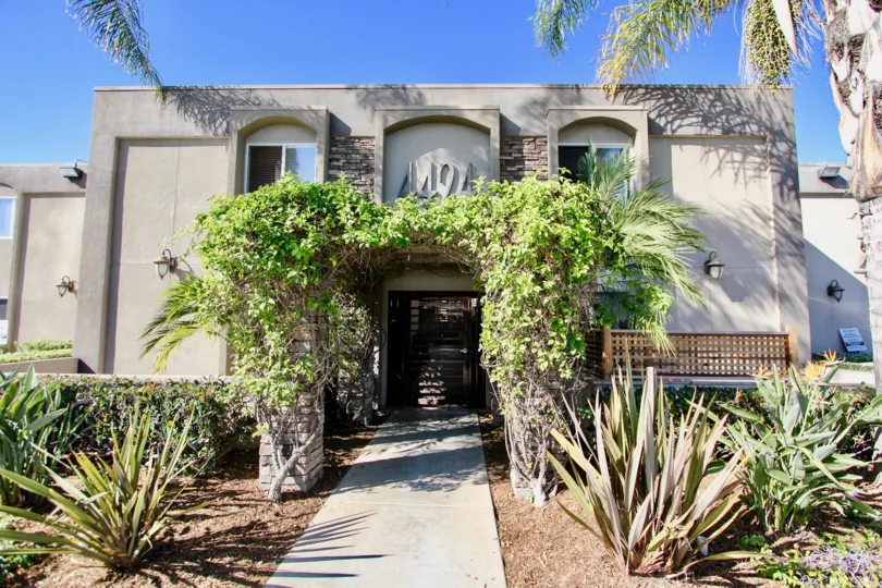 Two story housising with ivy covered entrance at Portico in College Area California