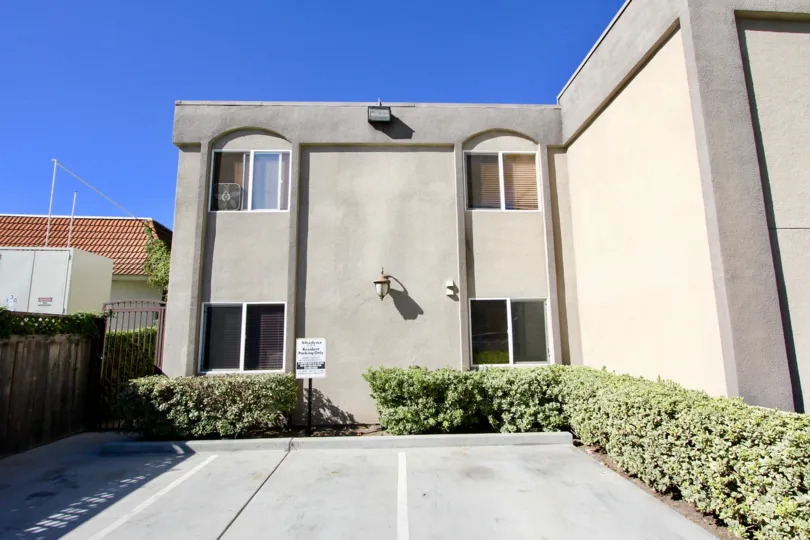 Two large lights above parking spaces at Portico in College Area CA