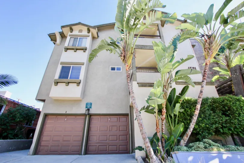 Off white 3 story unit with 2 separate garages located in Summit Place of College Area, California
